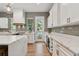 Gourmet kitchen with white cabinets, marble countertops, stainless steel appliances, and views to the outside at 238 7Th S Ave, Safety Harbor, FL 34695