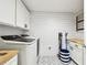 Bright laundry room features a modern washer, shiplap walls, stylish floor, and convenient built-in cabinets at 238 7Th S Ave, Safety Harbor, FL 34695