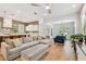 Bright living room with a large sectional couch, wood floors, and views of the kitchen and dining room at 238 7Th S Ave, Safety Harbor, FL 34695