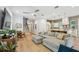 Comfortable living room with plush sectional, staircase, and open access to the kitchen at 238 7Th S Ave, Safety Harbor, FL 34695