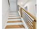 Modern staircase with wooden treads, white risers, and a sleek railing design at 238 7Th S Ave, Safety Harbor, FL 34695