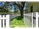 Charming home exterior with a well-manicured lawn and a classic white picket fence at 238 7Th S Ave, Safety Harbor, FL 34695