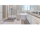 Bathroom with large soaking tub, walk-in shower, and dual sink vanity with granite countertops at 25200 Lambrusco Loop, Lutz, FL 33559