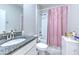 Clean bathroom featuring a granite countertop, white cabinetry, and a shower-tub combination with a pink curtain at 25200 Lambrusco Loop, Lutz, FL 33559