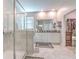 Bright bathroom with a walk-in shower, soaking tub, and a dual sink vanity at 25200 Lambrusco Loop, Lutz, FL 33559