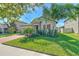 Single-Gathering home featuring a brick driveway and a well-maintained front lawn at 25200 Lambrusco Loop, Lutz, FL 33559