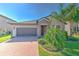Charming single-Gathering home featuring a brick driveway and a manicured front yard at 25200 Lambrusco Loop, Lutz, FL 33559