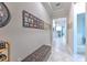 Bright hallway with tile floors, picture frames, and comfortable bench at 25200 Lambrusco Loop, Lutz, FL 33559