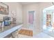 Hallway to bathroom with granite counter, coffee maker, and decorative rug at 25200 Lambrusco Loop, Lutz, FL 33559