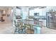 Open kitchen features white cabinetry, granite counters, and stainless appliances at 25200 Lambrusco Loop, Lutz, FL 33559
