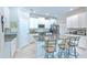 Well-equipped kitchen with stone counters, white cabinetry, and modern appliances at 25200 Lambrusco Loop, Lutz, FL 33559