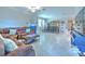 Open living space with a leather sofa, dining area, and tiled flooring, creating a welcoming and connected atmosphere at 25200 Lambrusco Loop, Lutz, FL 33559