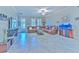 Spacious living room with tile floors, a comfortable leather sectional, and a view to the outside through bright windows at 25200 Lambrusco Loop, Lutz, FL 33559