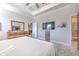 Main bedroom with carpet flooring, a flat screen tv, and walk in to the Primary bath at 25200 Lambrusco Loop, Lutz, FL 33559
