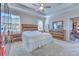 Bedroom with tray ceiling, bright natural lighting, and rustic style furniture at 25200 Lambrusco Loop, Lutz, FL 33559