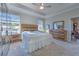 This main bedroom offers a tray ceiling, natural lighting, and rustic style furniture at 25200 Lambrusco Loop, Lutz, FL 33559