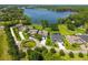 An aerial view showcasing upscale homes, manicured lawns, and a serene lake backdrop in a luxurious community at 2648 Lake Manor Dr, Land O Lakes, FL 34639