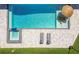 Aerial view of a custom pool, spa, patio area, and lounge chairs at 2648 Lake Manor Dr, Land O Lakes, FL 34639