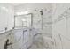 Luxurious bathroom boasts a marble-tiled shower with bench, built-in niches, and designer fixtures at 2648 Lake Manor Dr, Land O Lakes, FL 34639