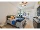 Comfortable carpeted bedroom with a ceiling fan, a computer desk, and a cozy bed at 2648 Lake Manor Dr, Land O Lakes, FL 34639