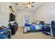 Comfortable bedroom with a sports theme, ceiling fan, and carpet flooring at 2648 Lake Manor Dr, Land O Lakes, FL 34639