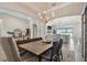 Open-concept dining area with view to living room and water at 2648 Lake Manor Dr, Land O Lakes, FL 34639