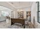 Elegant dining room with wooden table, bench, and chandelier at 2648 Lake Manor Dr, Land O Lakes, FL 34639