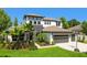 Charming two-story home with a three-car garage, and beautiful landscaping at 2648 Lake Manor Dr, Land O Lakes, FL 34639