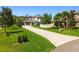 Beautiful home with a well-maintained lawn and spacious driveway, surrounded by green trees at 2648 Lake Manor Dr, Land O Lakes, FL 34639
