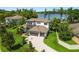 Stunning two-story home with lush landscaping, long driveway, and a serene lake view at 2648 Lake Manor Dr, Land O Lakes, FL 34639
