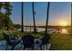 Waterfront firepit with Adirondack chairs, perfect for enjoying lake views at sunset at 2648 Lake Manor Dr, Land O Lakes, FL 34639