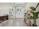 Inviting foyer with wood-look tile flooring, a console table and natural light at 2648 Lake Manor Dr, Land O Lakes, FL 34639