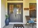 Classic front entrance with a welcoming doormat, chairs and well-lit design at 2648 Lake Manor Dr, Land O Lakes, FL 34639