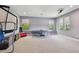 Spacious game room with recreation equipment and bright natural light at 2648 Lake Manor Dr, Land O Lakes, FL 34639