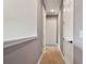 Hallway with neutral-colored walls and carpeting, with doors to nearby rooms at 2648 Lake Manor Dr, Land O Lakes, FL 34639