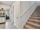 Hallway featuring a staircase, doors to various rooms, and neutral tones at 2648 Lake Manor Dr, Land O Lakes, FL 34639