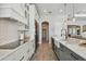Modern kitchen boasting custom white cabinets, gray lower cabinets, and a spacious center island at 2648 Lake Manor Dr, Land O Lakes, FL 34639