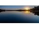 Panoramic view of tranquil lake at sunrise, with calm water and clear sky at 2648 Lake Manor Dr, Land O Lakes, FL 34639
