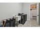 A functional laundry room with modern washer and dryer, utility sink, and convenient access to storage at 2648 Lake Manor Dr, Land O Lakes, FL 34639