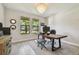 Bright home office with large windows, natural light, stylish decor, and wood-look floors at 2648 Lake Manor Dr, Land O Lakes, FL 34639