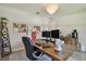 Spacious home office features a large wooden desk, modern decor, and plenty of natural light at 2648 Lake Manor Dr, Land O Lakes, FL 34639
