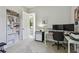 Well-lit office area featuring neutral carpet, a shelving unit, and a white desk workspace at 2648 Lake Manor Dr, Land O Lakes, FL 34639