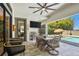 Outdoor dining and seating with a TV and grill. Enjoy views of the pool and lake at 2648 Lake Manor Dr, Land O Lakes, FL 34639