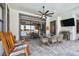 Covered patio features an outdoor kitchen, dining, and seating with pool view at 2648 Lake Manor Dr, Land O Lakes, FL 34639
