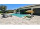 Beautiful pool features a lounge area in the water and comfortable lounge chairs at 2648 Lake Manor Dr, Land O Lakes, FL 34639