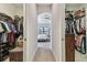 Dual walk-in closets lead to a bedroom with a tray ceiling and natural light at 2648 Lake Manor Dr, Land O Lakes, FL 34639