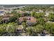 Aerial view of a multi-story condo building surrounded by trees and landscaping at 2650 Countryside Blvd # C204, Clearwater, FL 33761