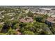 An aerial view of a condo complex featuring mature trees and serene landscaping, set in a convenient location close to amenities at 2650 Countryside Blvd # C204, Clearwater, FL 33761