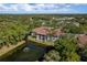 A high-angle view of the condo building showcasing the central courtyard, red-tile roofs, and lush surrounding greenery at 2650 Countryside Blvd # C204, Clearwater, FL 33761