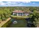 A beautiful aerial view shows this condo community surrounded by a pond and lush landscape at 2650 Countryside Blvd # C204, Clearwater, FL 33761